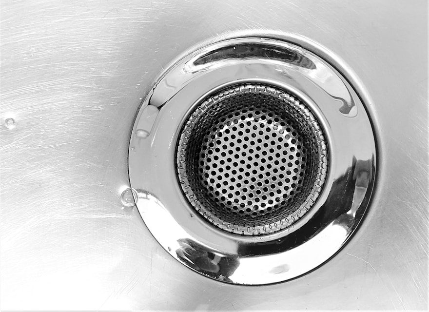 Close-up of a stainless steel kitchen sink drain