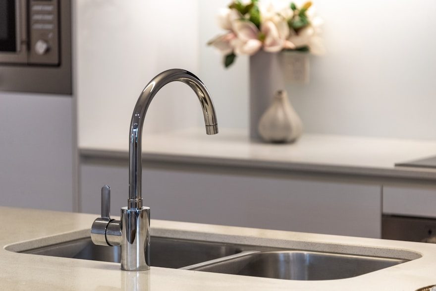 A chrome kitchen faucet over a double sink
